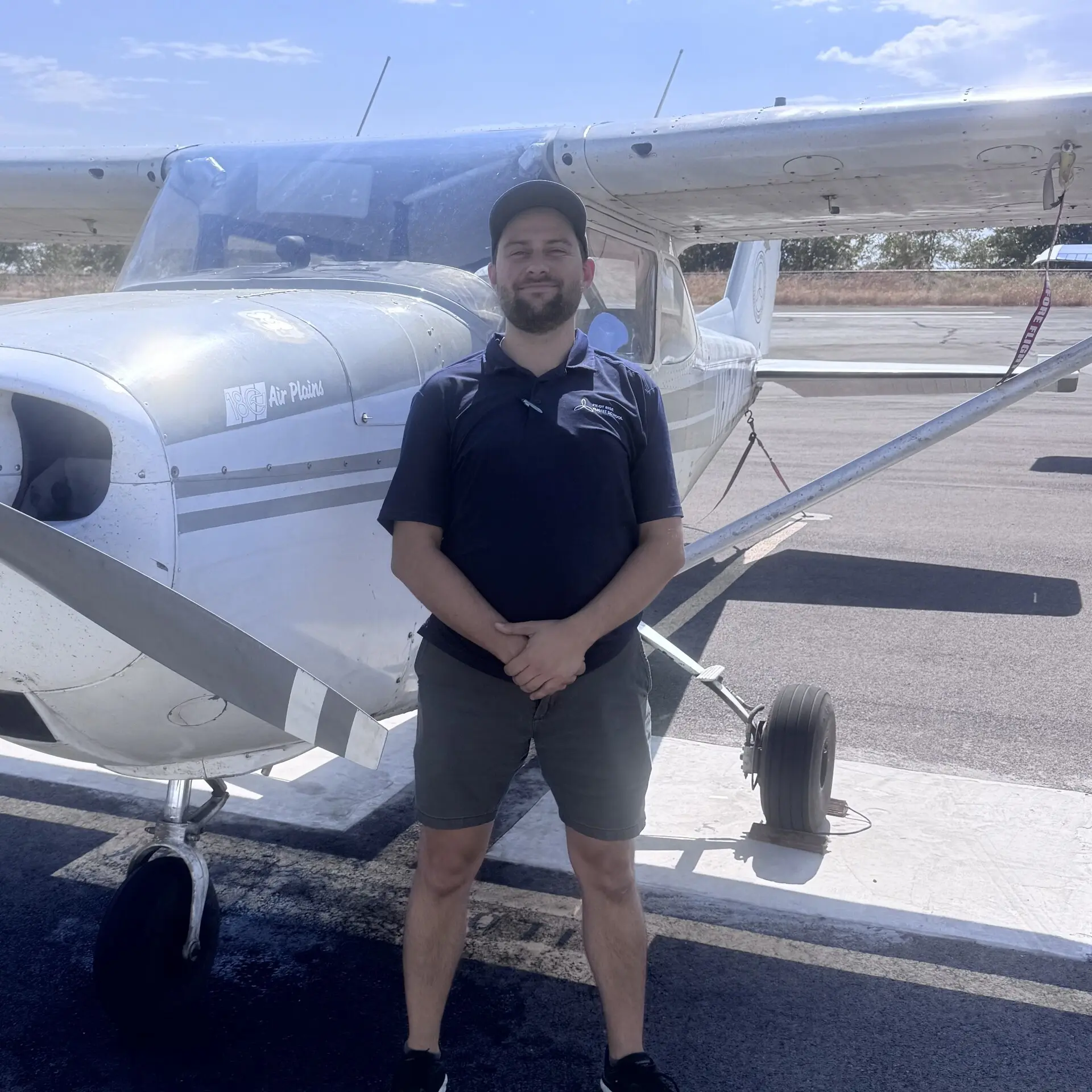 Andrew Dahlstrom, Pilot Rise flight instructor, standing in front of a Cessna