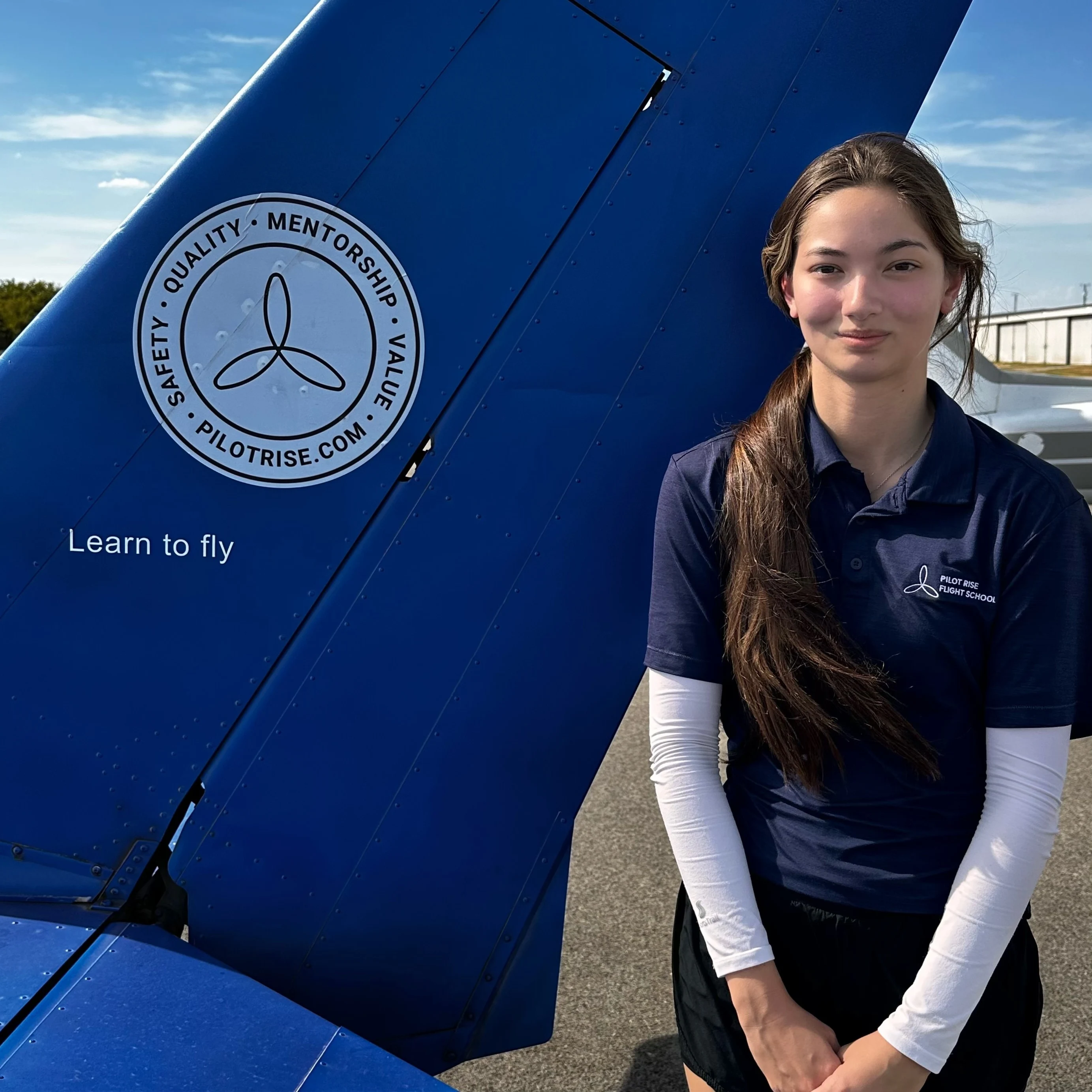 Jayna Moore, Pilot Rise flight instructor, beside a Pilot Rise aircraft at Hicks Airfield