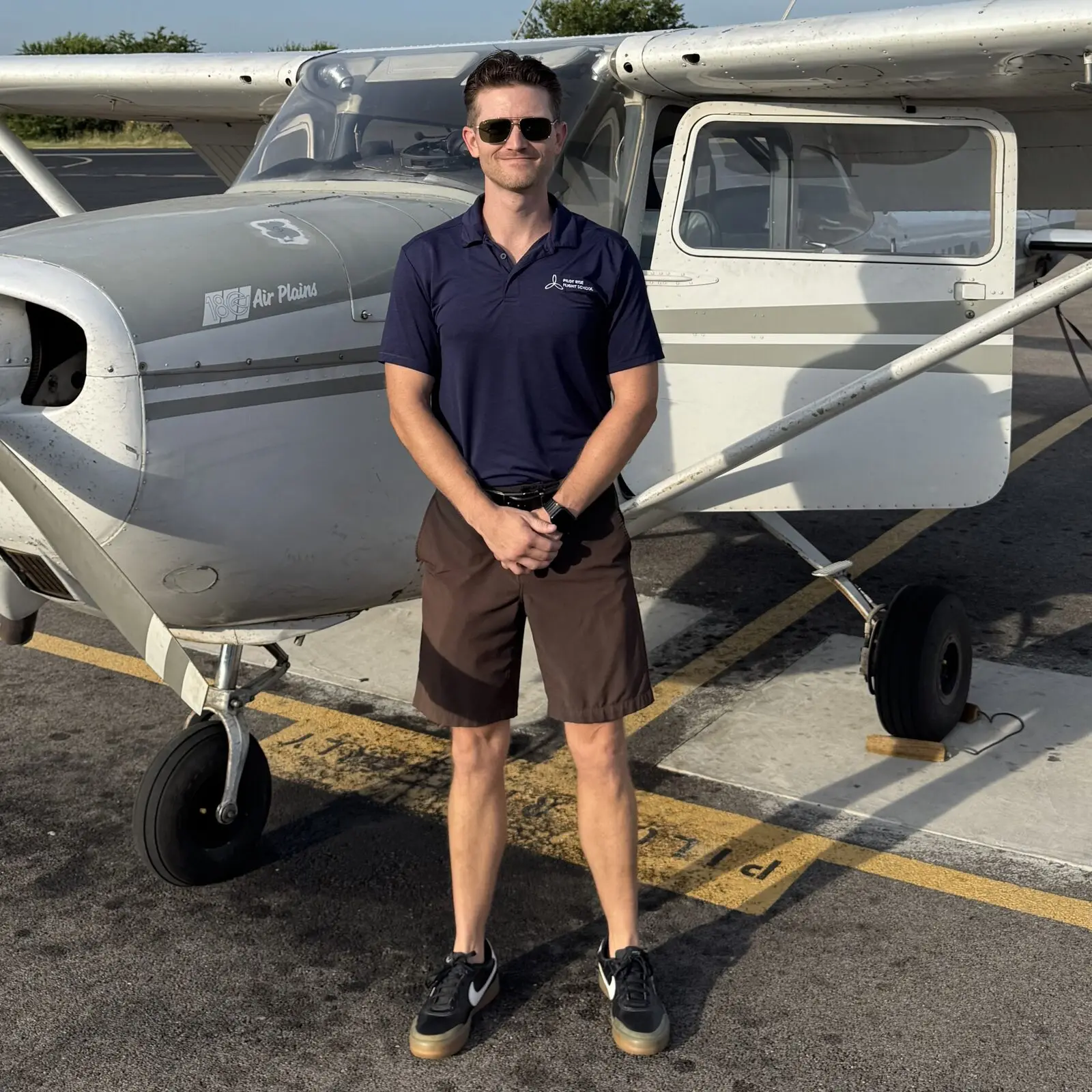 Jordan Connors, chief flight instructor at Pilot Rise Hicks Airfield, standing by a Cessna