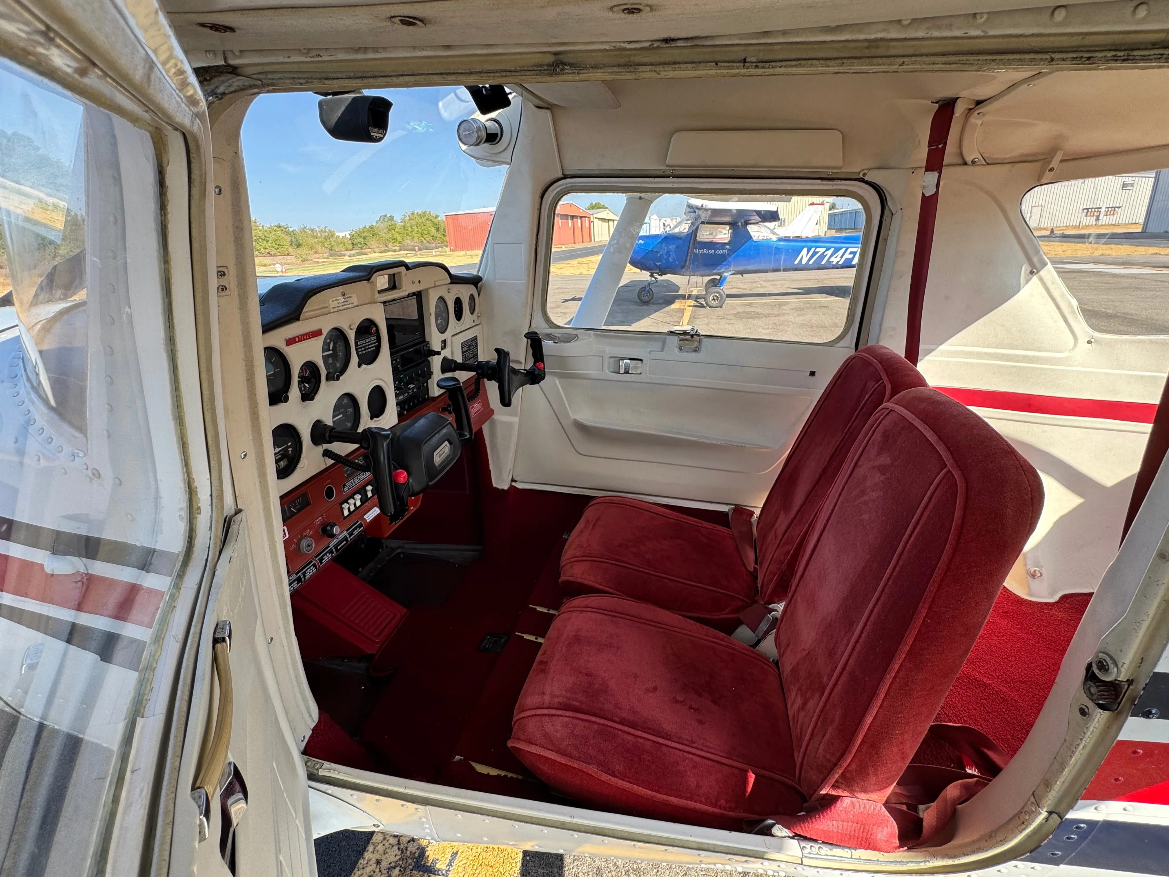 Red seats and cabin interior inside Cessna 150M N714LZ Scout