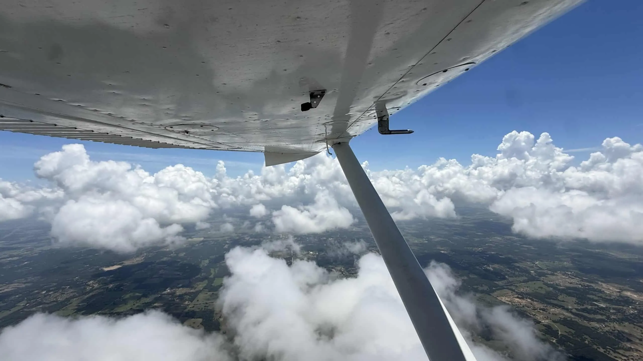 How long does it take to become a pilot? Pilot Rise Cessna 172 wing above Dallas-Fort Worth.